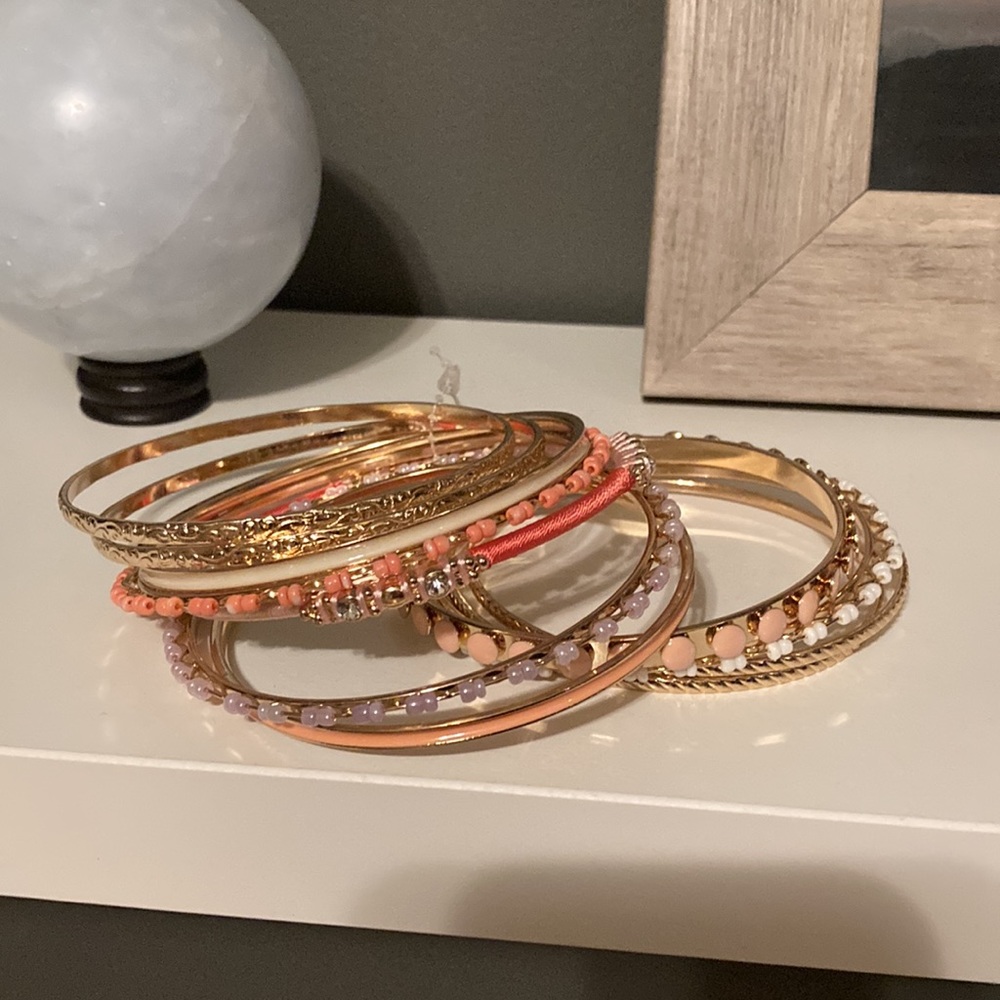 BNWOT set of costume jewelry bangles. Beautiful coral colours!